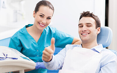 Man with dentist giving thumbs up