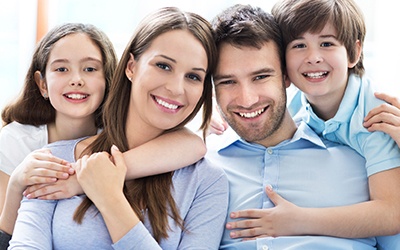 Smiling parents and two kids