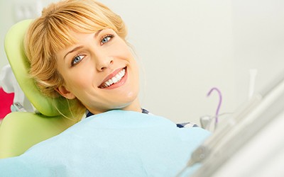 Smiling woman in dentist chair