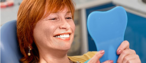 Woman looking at her restored smile