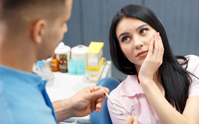 Woman holding face in pain