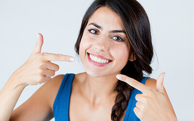Woman pointing at bright smile