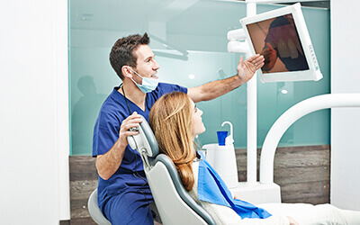 Dentist showing patient dental images