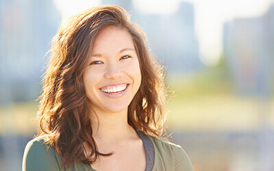 Woman in green sweater smiling